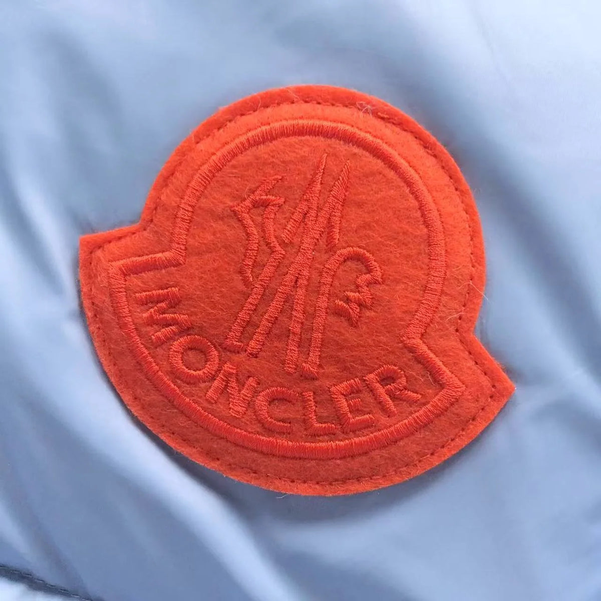 Moncler Light Blue Hooded Puffer Jacket with Orange Logo Patch
